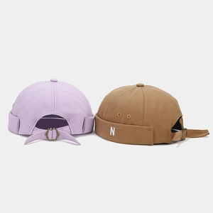 Close-up of vintage docker hats featuring cotton canvas texture and metal adjustment buckle