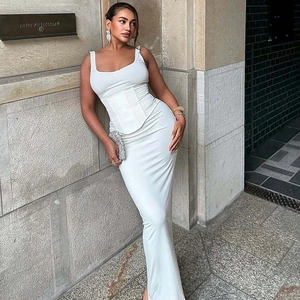 Detailed view of a white slim fit corset top and long skirt set with zipper and lace-up details