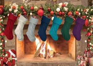 Knitted Christmas stockings in various colors hanging on a fireplace with holiday decor