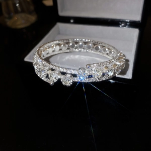 Close-up of a luxury multi-layer flower bangle with crystals in a black jewelry box