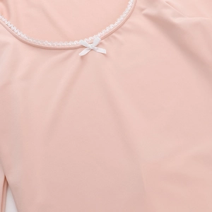 Close-up of pink square neck top showing white lace trim and bow knot detail