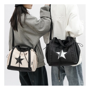 Dual-view of couple crossbody bags with star logo and adjustable drawstring details