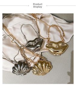 Miniature metal lip and shell evening bags with golden and silver mirror finish on silk