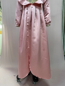 Detail of pink satin evening gown with heavy beadwork on the collar and long sleeves