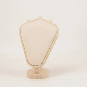 Close-up of wooden necklace display stand with beige velvet padding and round base