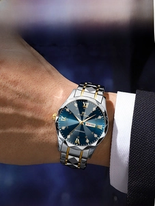Detail of luxury men's business watch with blue dial, day-date window, and dual-tone band