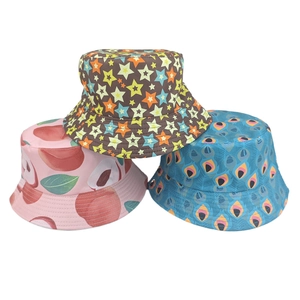 Detailed view of printed bucket hats featuring star, peach, and peacock feather patterns
