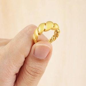 Unique 18K gold-plated irregular twisted chain open ring shown on a light wood surface