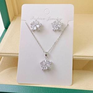 Detailed view of silver flower jewelry set with sparkling crystals in a gift box