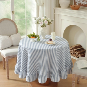 Close-up of blue and white striped cotton-linen tablecloth with ruffle hem detail