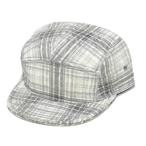 Detailed view of gray and white checkered camper hat with 5-panel design and flat brim