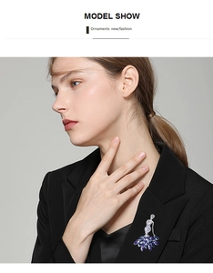 Detail of elegant mermaid brooch with blue crystals on black blazer lapel for women