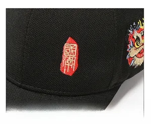 Macro detail of Chinese lion dance embroidery on a black textured baseball cap