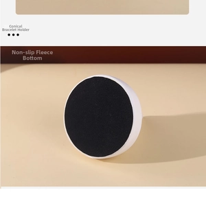 Macro detail of jewelry stand base featuring black non-slip velvet for stability