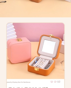 Detail view of leather jewelry box featuring ring slots, necklace hooks and makeup mirror