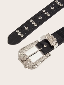 Detail of black croc-embossed belt with silver butterfly buckle and sparkling rhinestones