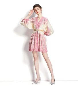 Close-up of V-neck paisley print mini dress with lantern sleeves and woven belt detail