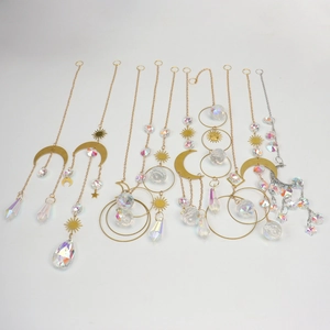 Detailed view of assorted crystal suncatchers with gold and silver celestial moon charms