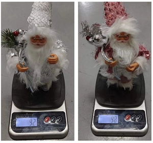 Detailed comparison of 9-inch pink and white Santa figurines on digital scales showing weight