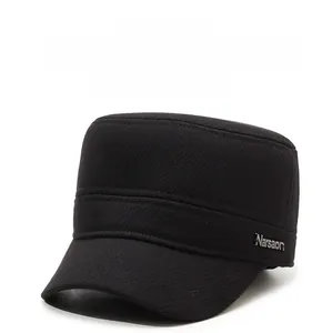 Detail view of the black thermal flat top hat featuring ear protection and metal logo