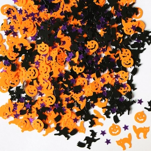 Halloween party confetti with orange pumpkins, black witches, bats, and purple stars