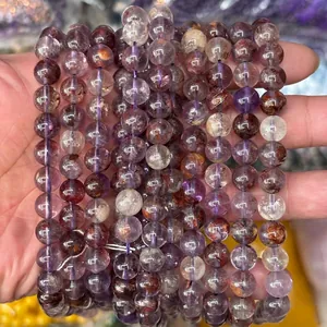 Macro view of natural purple phantom quartz beads with rich mineral inclusions