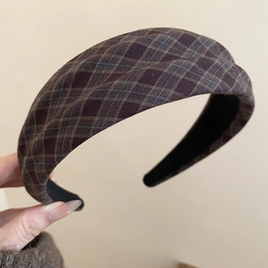 Macro shot of brown plaid fabric headband showing texture and non-slip inner lining