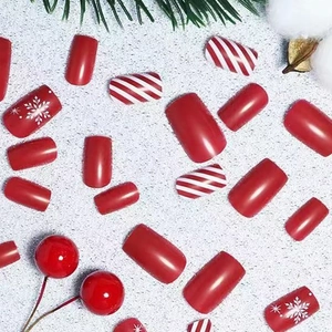Short square red Christmas press-on nails with white snowflakes and candy stripes