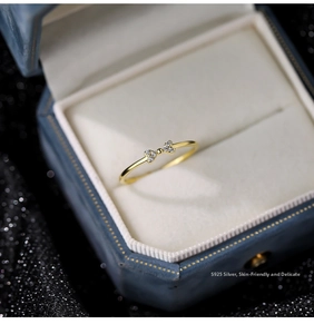 Close-up of S925 sterling silver bow ring with zircon stones in a blue gift box