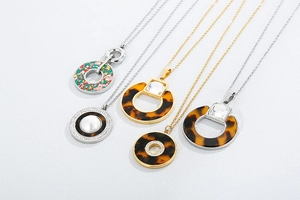 Close-up of geometric necklaces with tortoiseshell resin and crystal charms