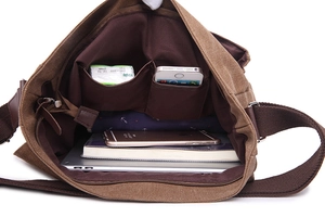 Internal view of brown canvas messenger bag showing spacious main compartment and pockets