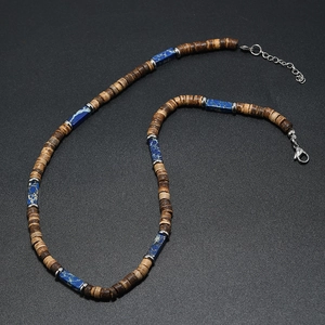 Detail of bohemian necklace featuring brown wood beads and blue stone accents