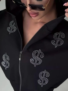Women's black zip-up hoodie featuring sparkling rhinestone dollar sign graphics