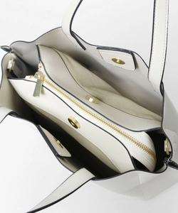 Top view of cream PU leather tote bag with three compartments and gold zipper detail