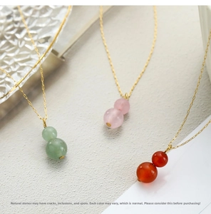 Detailed view of natural red agate, aventurine, and rose quartz gourd pendants with gold chains