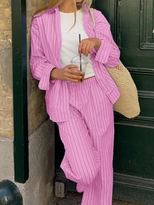 Detailed macro shot of pink and white striped cotton-linen shirt and elastic waist pants
