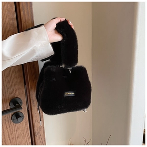 Detail of black plush bucket bag showing soft texture and love every day tag
