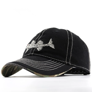 Close-up of fishbone embroidery and contrast stitching on a black baseball cap