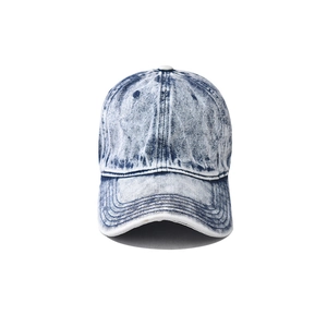 Detailed close-up of acid wash denim baseball cap fabric and reinforced stitching