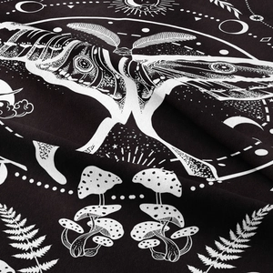 Close-up of bohemian butterfly tapestry with celestial motifs and mushroom prints