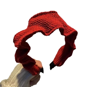 Elegant red knitted headband for women featuring a textured pleated crochet wave design