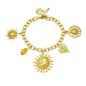 Detailed view of gold sun pendants and green heart bead on a link chain bracelet