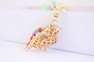 Detail of a gold kingfisher bird keychain with colorful rhinestones and hollow design