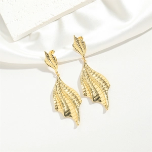 Elegant gold leaf metal earrings with detailed plant textures on a silk background