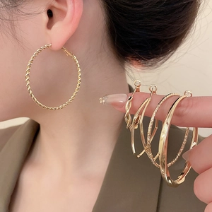 Close-up of assorted gold hoop earrings with twisted spiral and polished textures