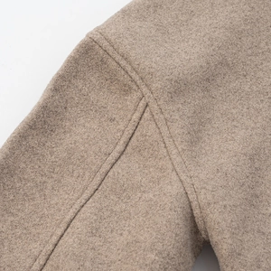 Macro shot of light brown wool fabric texture and fine stitching on the lapel