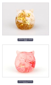 Detail of owl resin figurines with white shell gold foil and pink crystal with sequins
