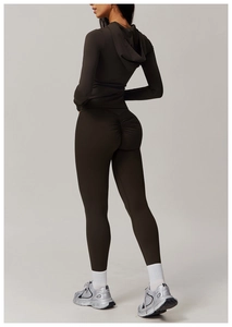 Detail of dark brown scrunch butt yoga leggings and zip-up hoodie set on model