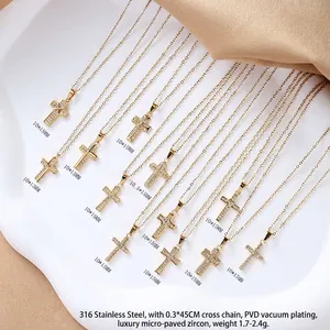Golden 316L stainless steel cross necklace with micro-paved zircons on a white tray