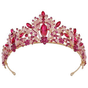 Exquisite gold bridal crown with pink crystals and leaf design on white background